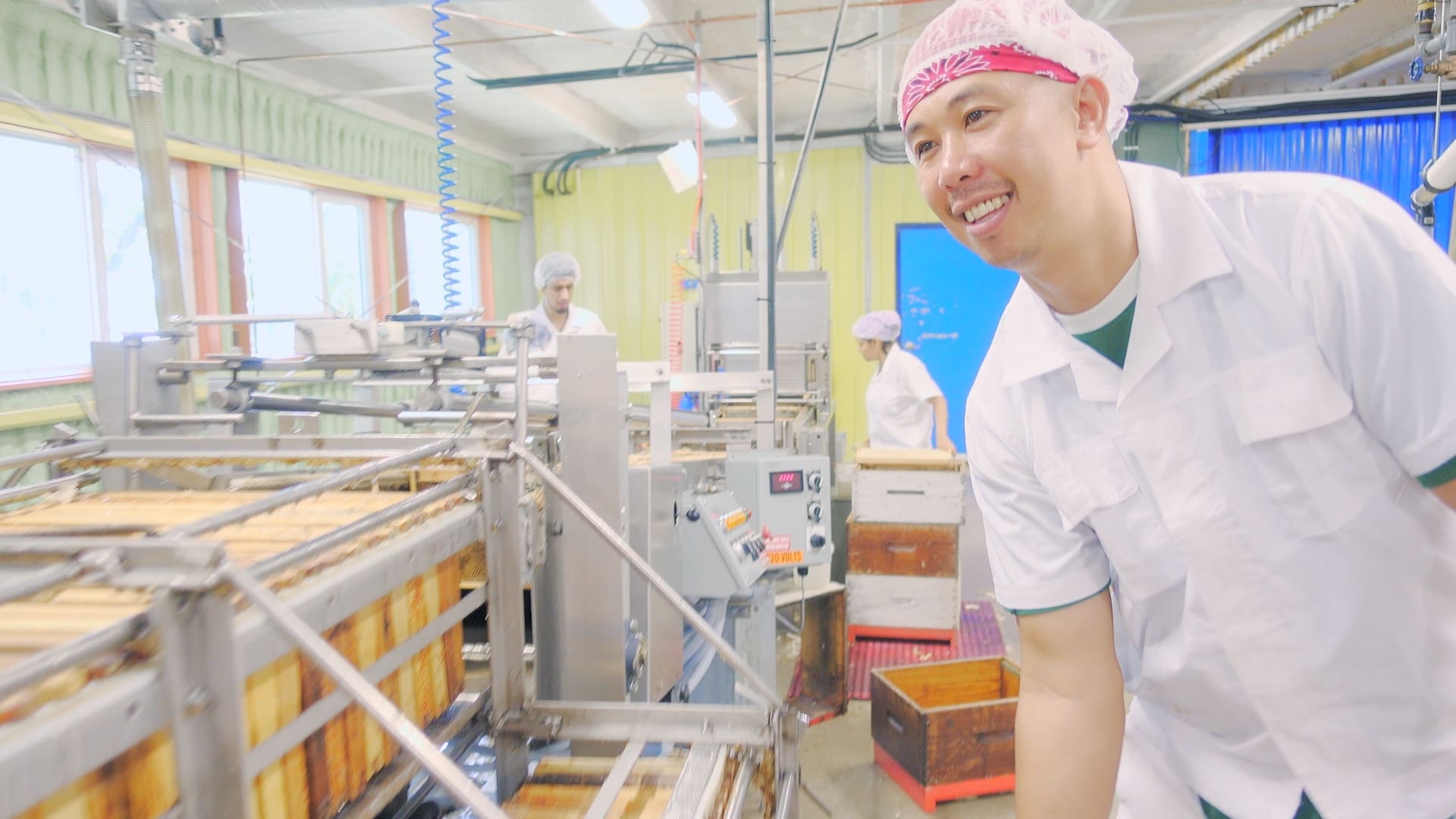 Rolly operates a honey extraction unit, spinning the honey out of honey combs brought in the previous day