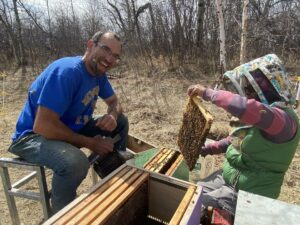 ake and Zulema transfer a 5-frame nucleus colony into a full-size production hive