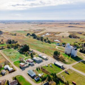 See the beehives 1.5 miles (2.4 km) from the village in the background? They're too far to see, but the chemicals used on lawns and gardens would disqualify them from organic certification.