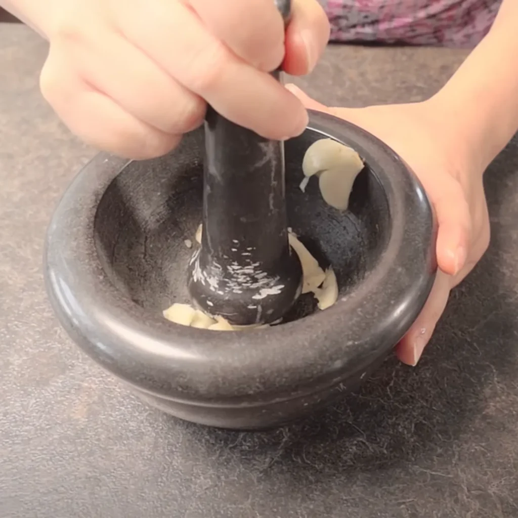 Smash the garlic with a mortar and pestle if you have one.