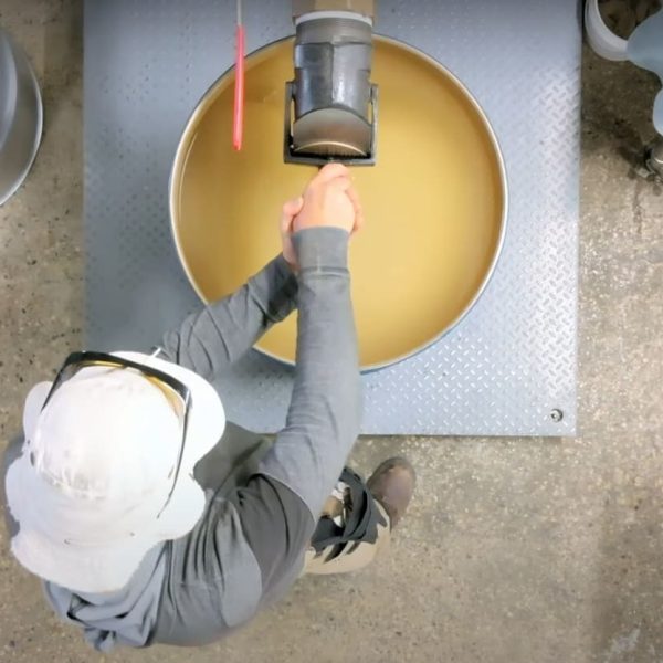 Chris fills bulk drums on Wendell Honey farm. The majority of our premium honey is still sold in bulk. It has a long journey before it arrives, blended and aged, at the customers home. Photo credit: WEH beekeeper, Brent Richard Ross