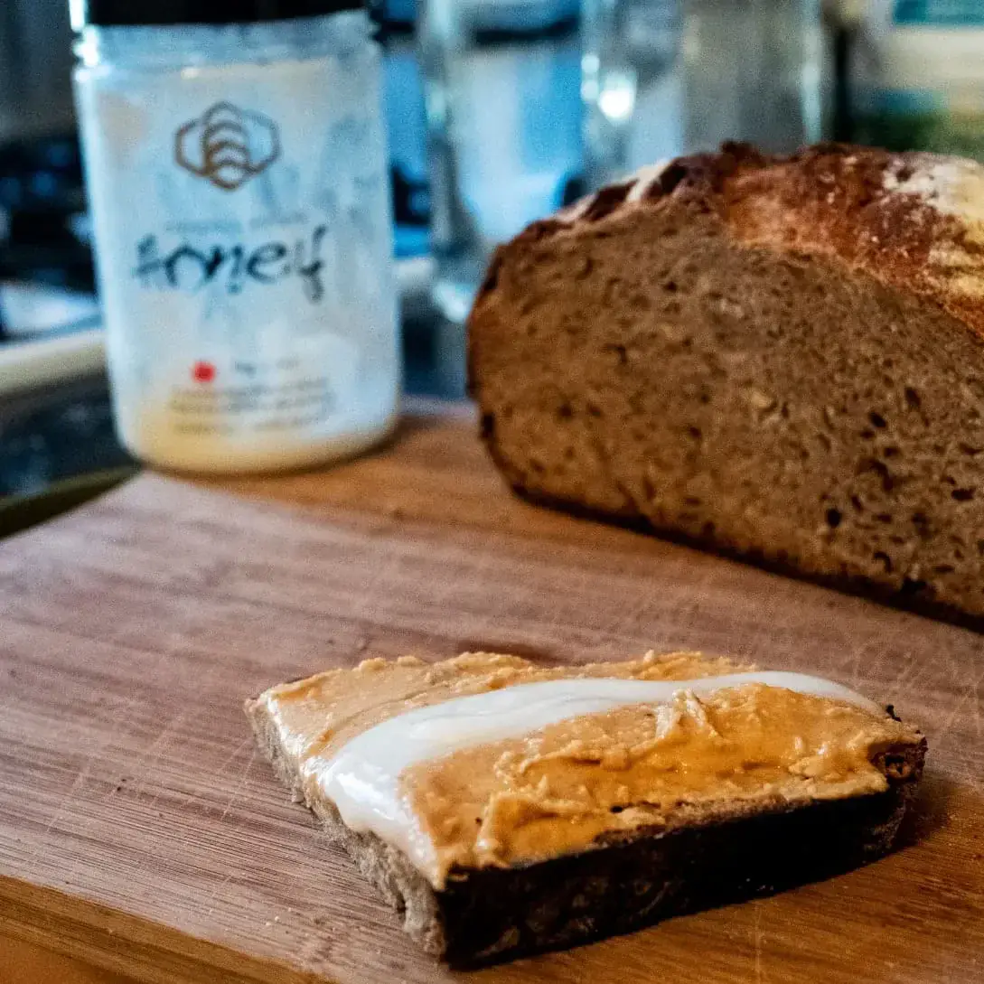 Raw honey and peanut butter on home-made multi-grain bread